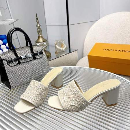 a pair of Louis Vuitton LV Mare Mule in white on a table
