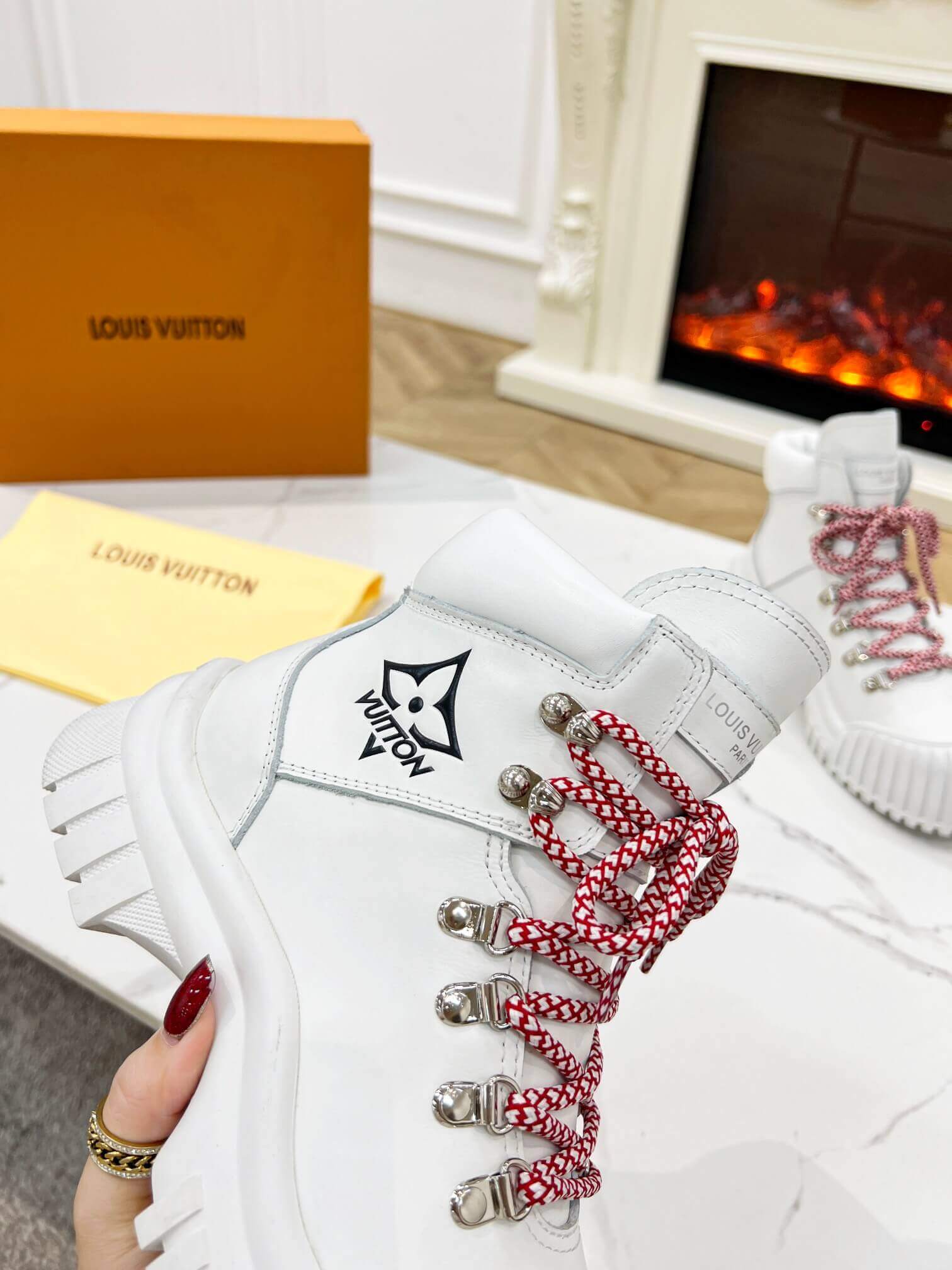 a pair of Louis Vuitton LV Ranger Boot In White Leather with Red Laces