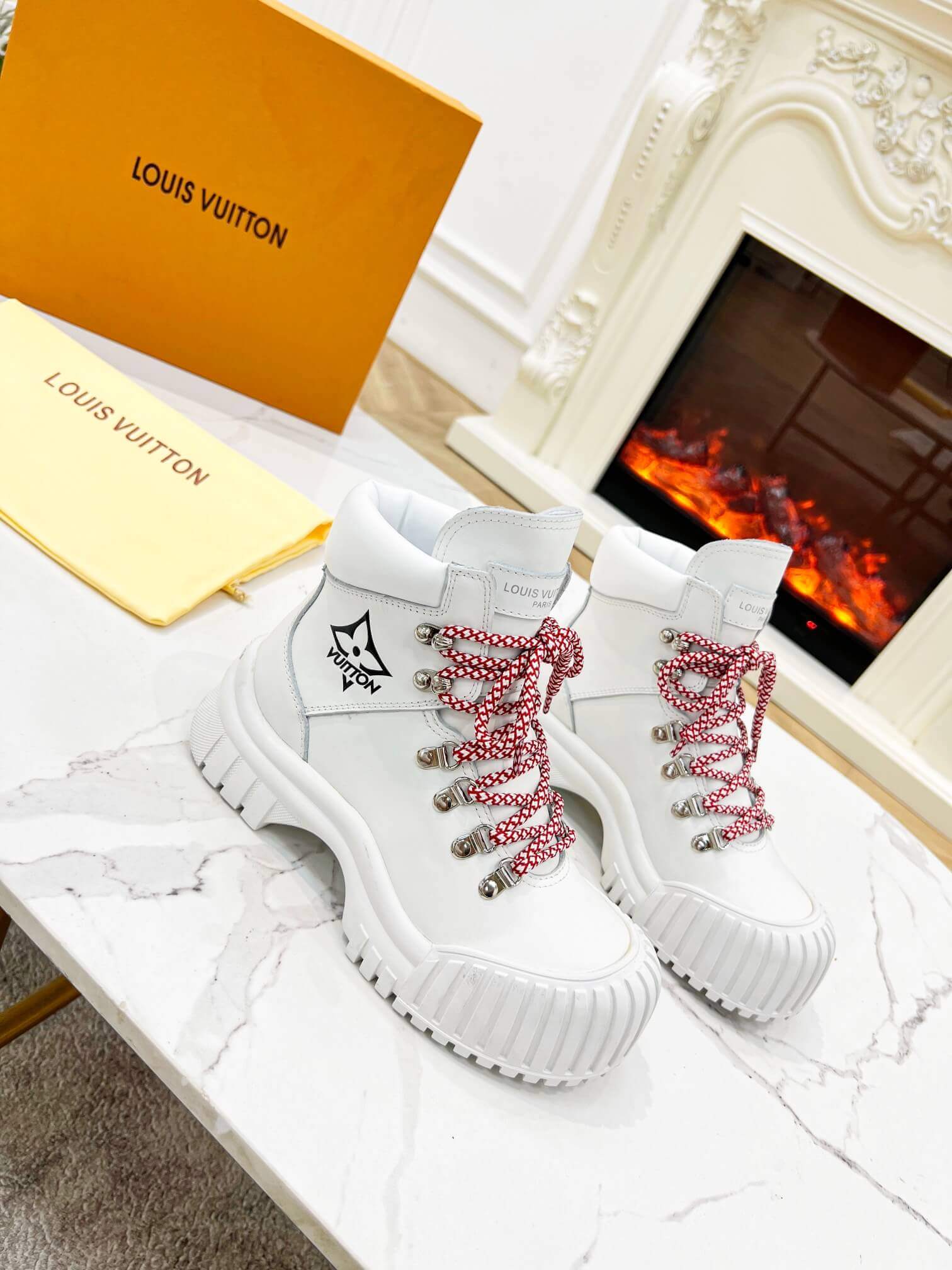 a pair of Louis Vuitton LV Ranger Boot In White Leather with Red Laces
