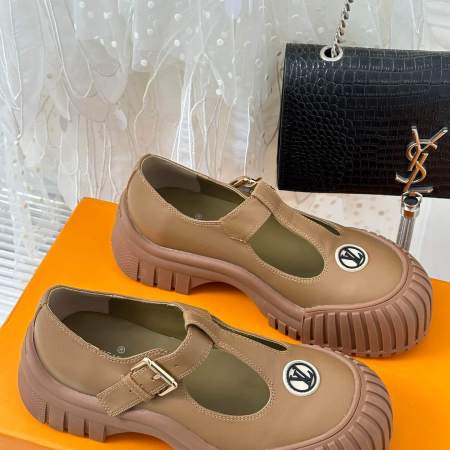 a pair of Louis Vuitton LV Ruby Flat Mary Jane in beige. on a yellow box