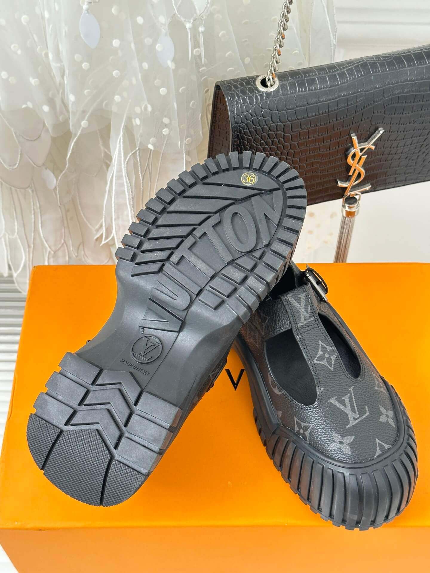 a pair of Louis Vuitton LV Ruby Flat Mary Jane in black Monogram canvas.