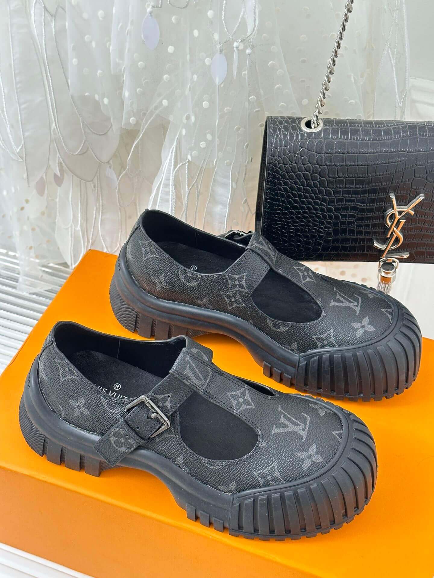 a pair of Louis Vuitton LV Ruby Flat Mary Jane in black Monogram canvas.