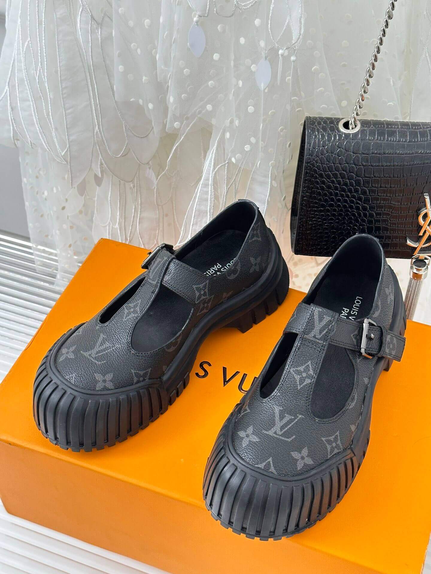 a pair of Louis Vuitton LV Ruby Flat Mary Jane in black Monogram canvas.