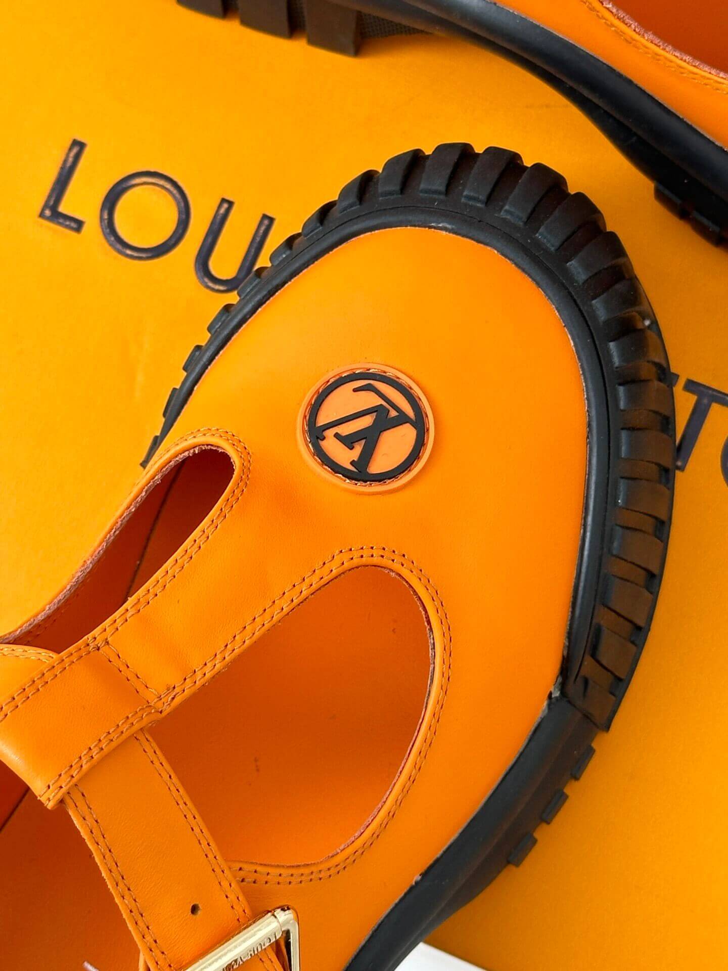 a pair of Louis Vuitton LV Ruby Flat Mary Jane in orange and black