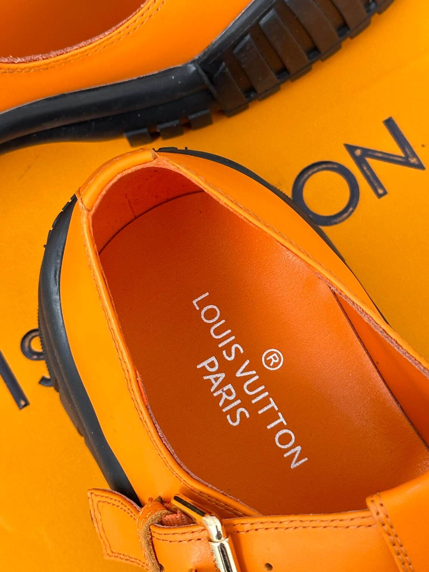 a pair of Louis Vuitton LV Ruby Flat Mary Jane in orange and black