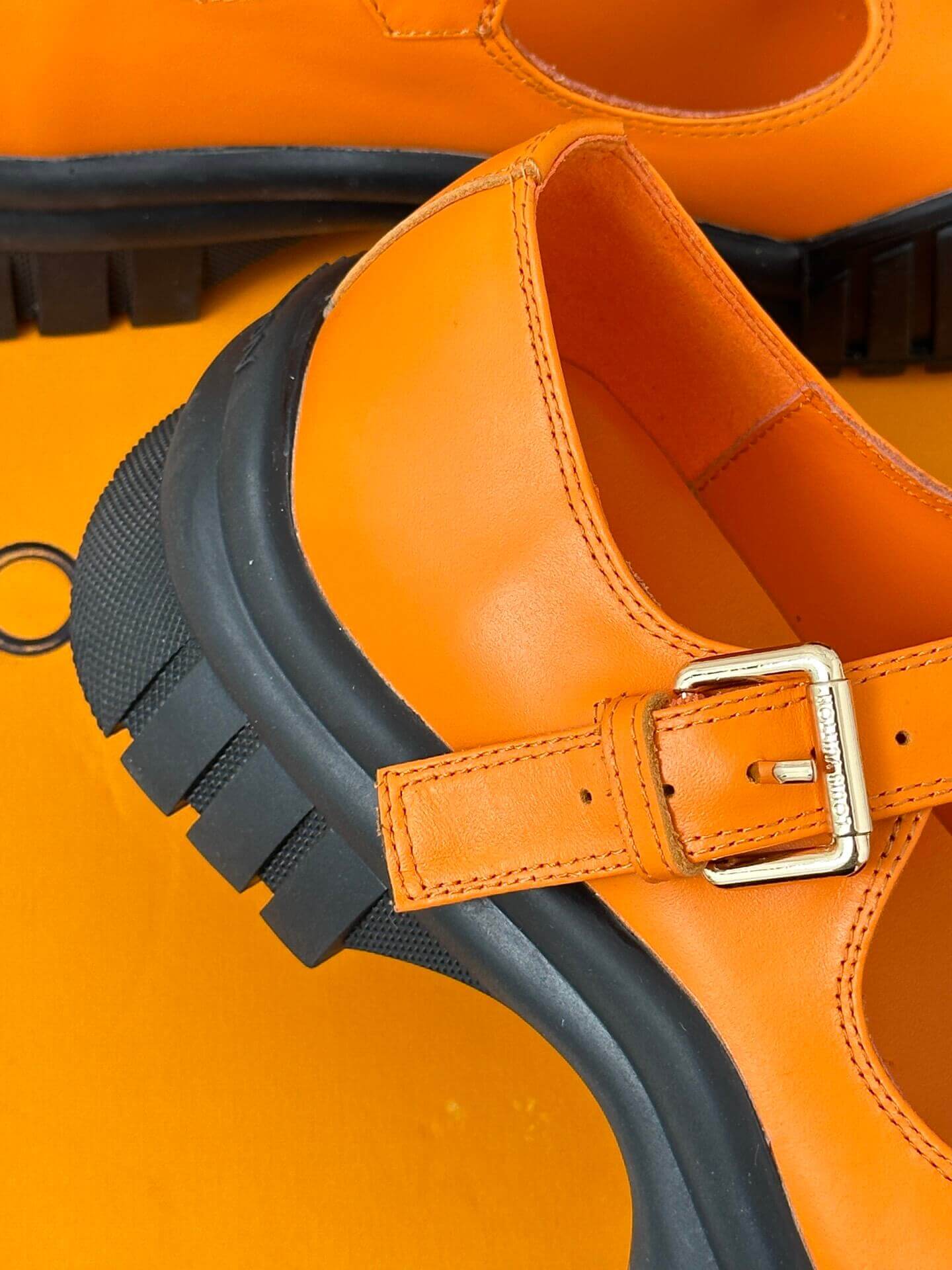 a pair of Louis Vuitton LV Ruby Flat Mary Jane in orange and black