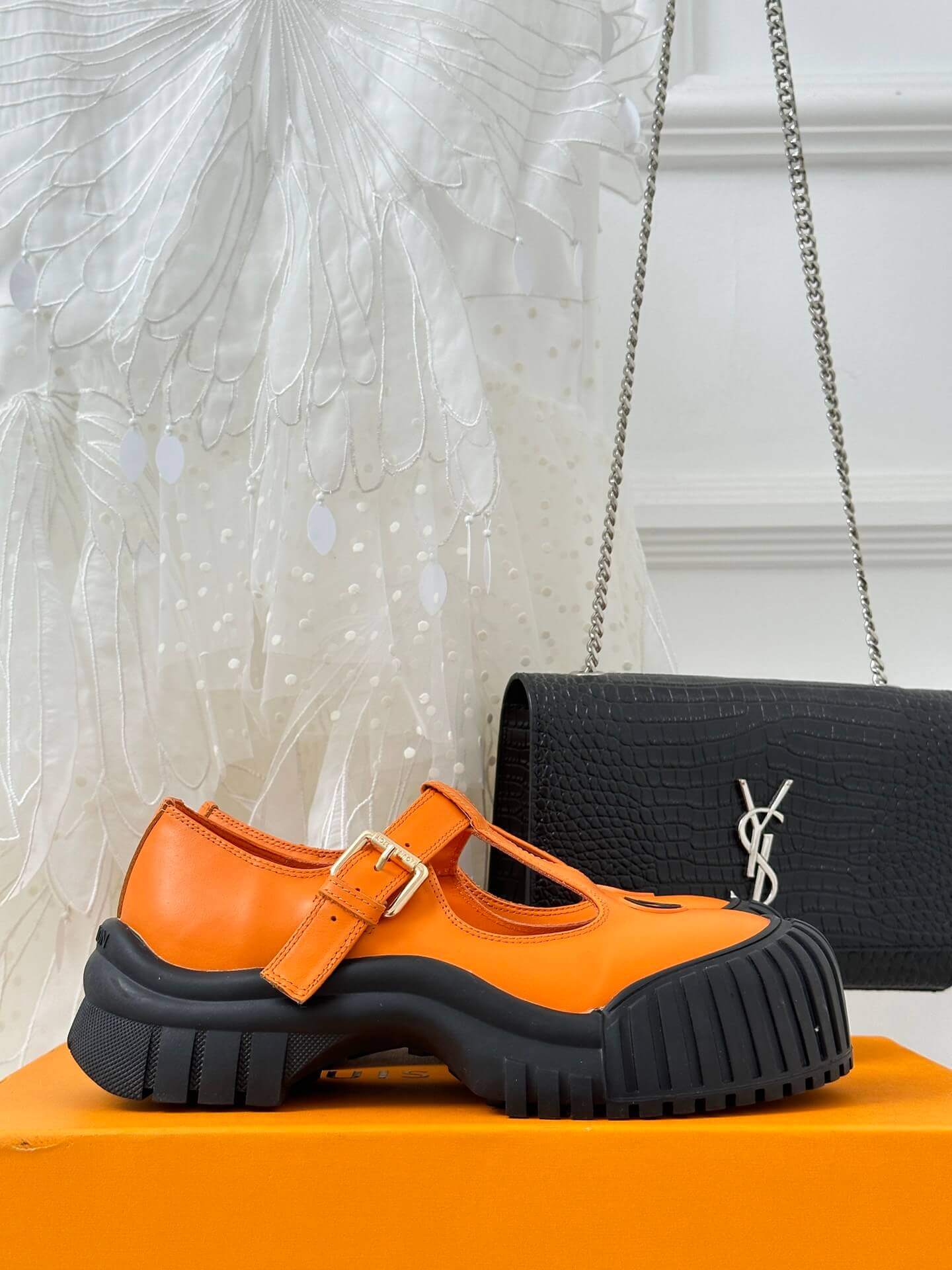 a pair of Louis Vuitton LV Ruby Flat Mary Jane in orange and black