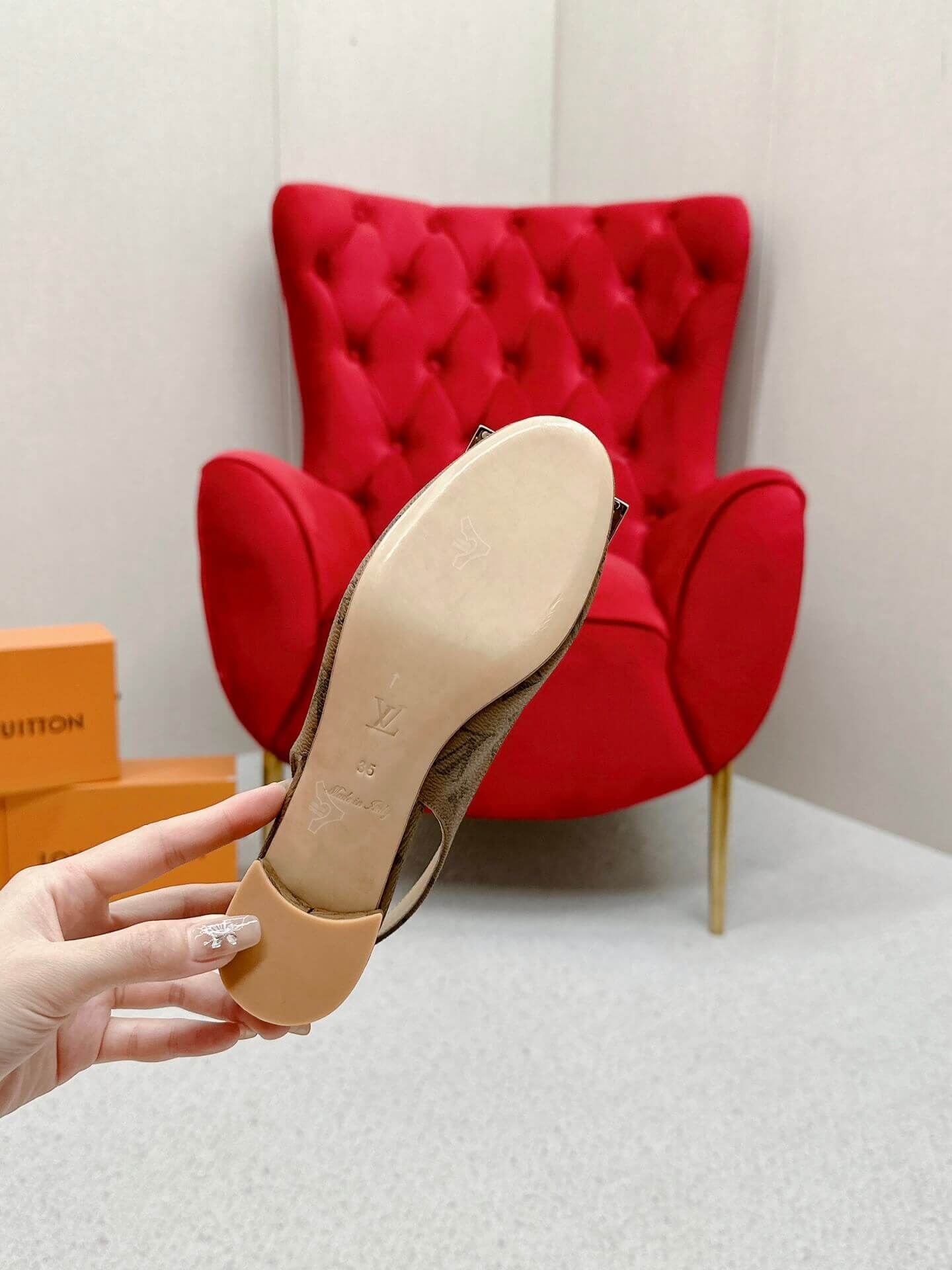 a pair of Louis Vuitton Madeleine Slingback Pump in Monogram canvas on a marble surface