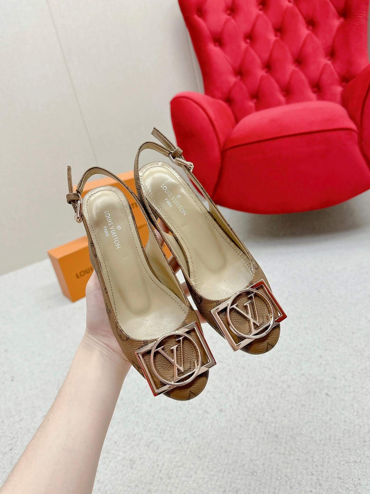 a pair of Louis Vuitton Madeleine Slingback Pump in Monogram canvas on a marble surface
