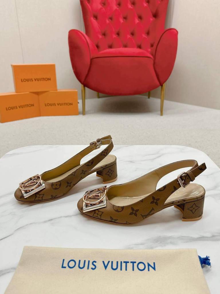 a pair of Louis Vuitton Madeleine Slingback Pump in Monogram canvas on a marble surface