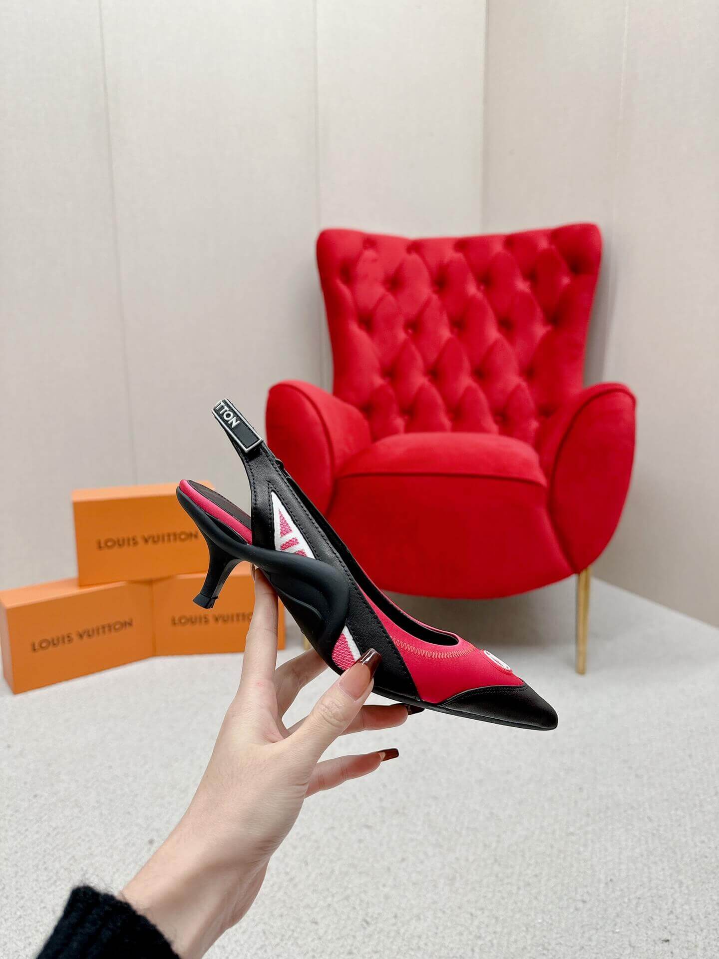 a pair of Louis Vuitton Madeleine Slingback Pump in hot pink combined black