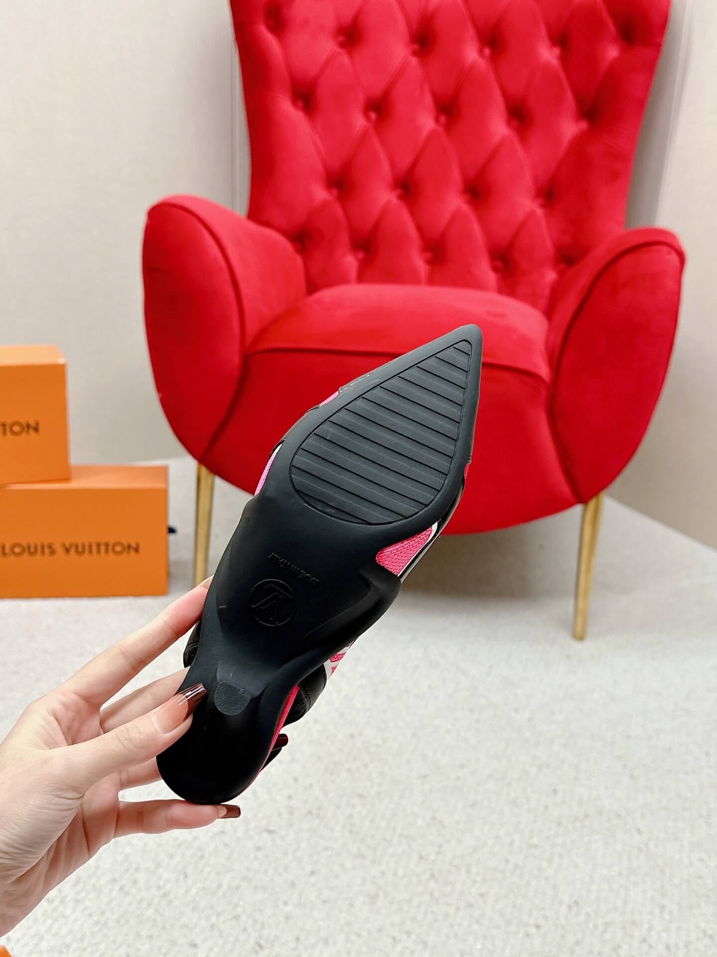 a pair of Louis Vuitton Madeleine Slingback Pump in hot pink combined black