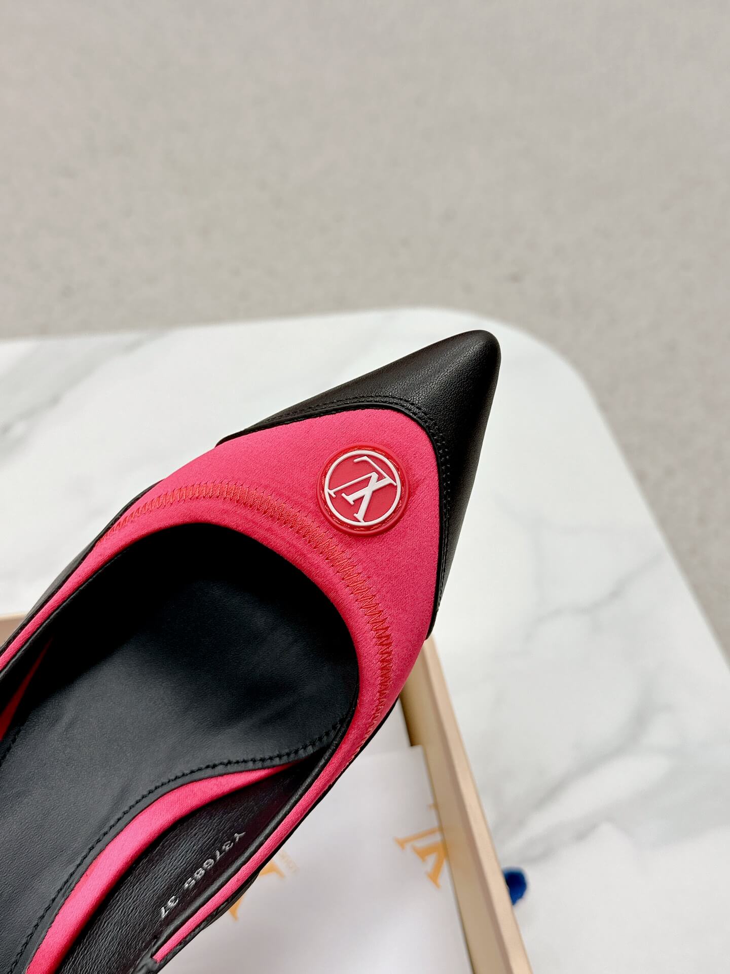 a pair of Louis Vuitton Madeleine Slingback Pump in hot pink combined black