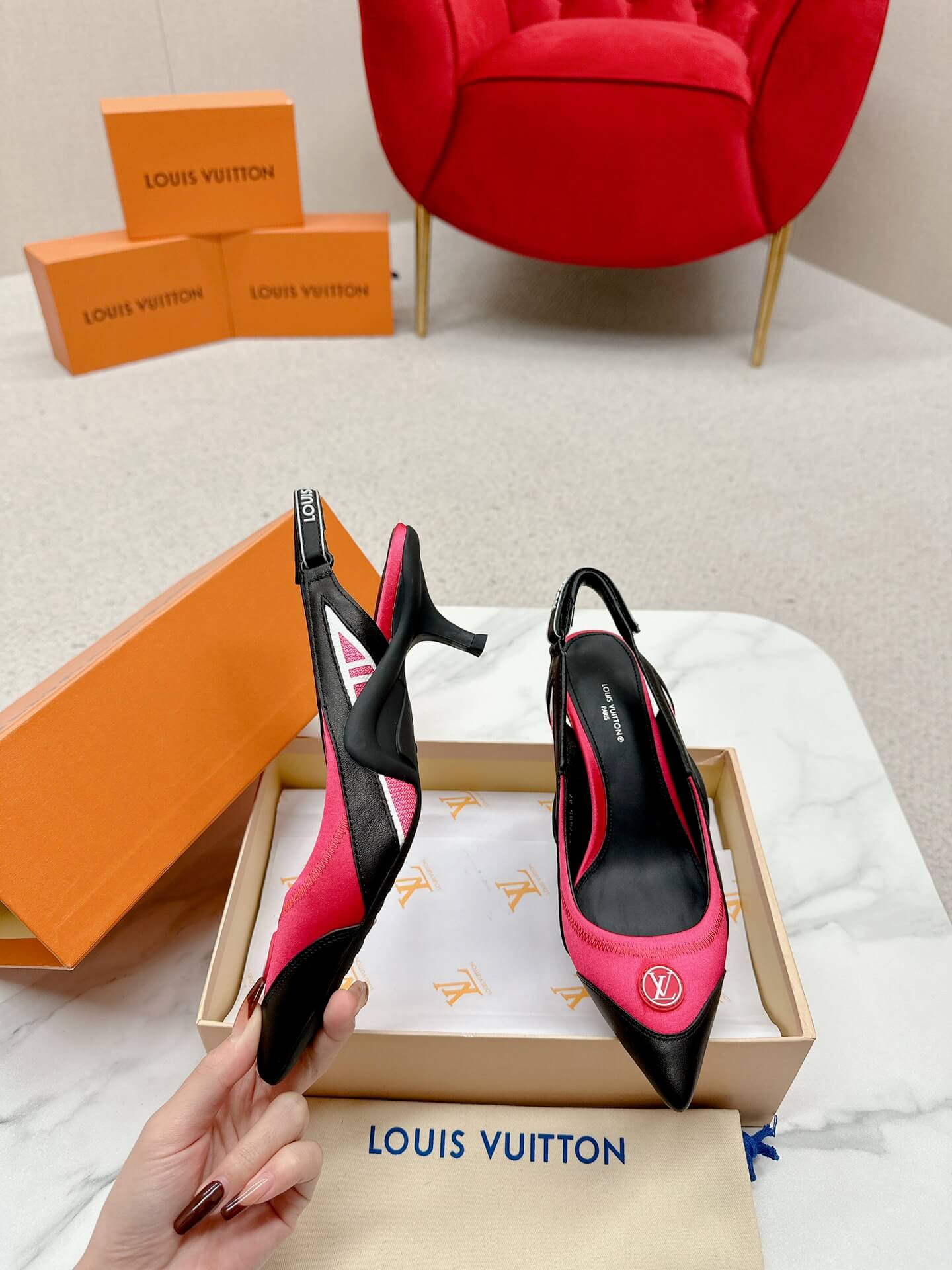 a pair of Louis Vuitton Madeleine Slingback Pump in hot pink combined black