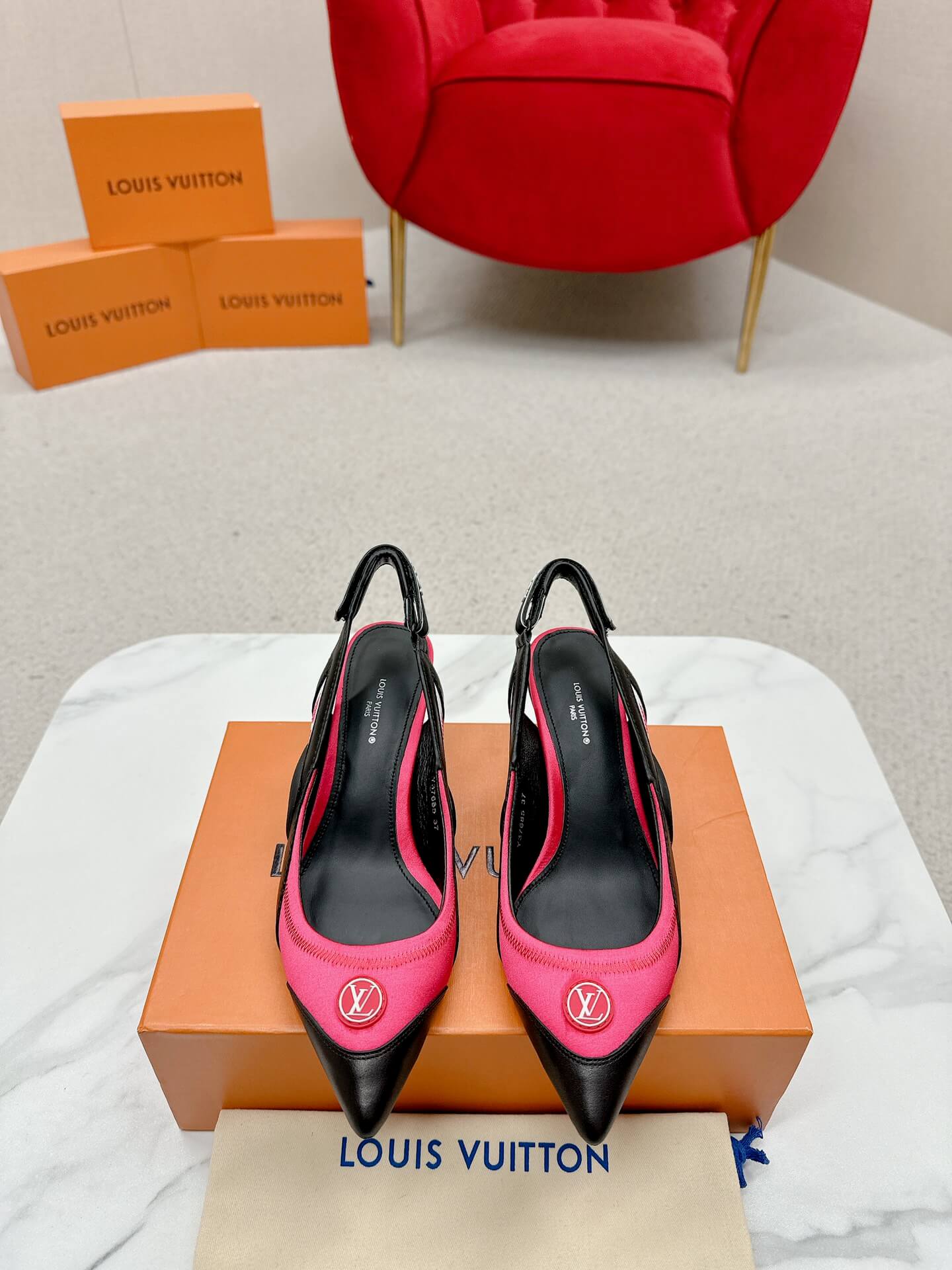 a pair of Louis Vuitton Madeleine Slingback Pump in hot pink combined black