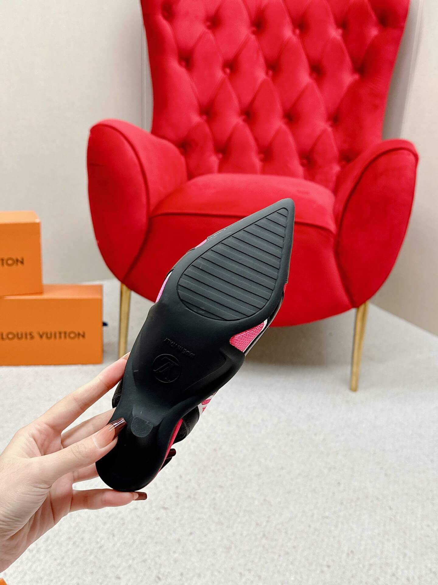 a pair of Louis Vuitton Madeleine Slingback Pump in hot pink combined black