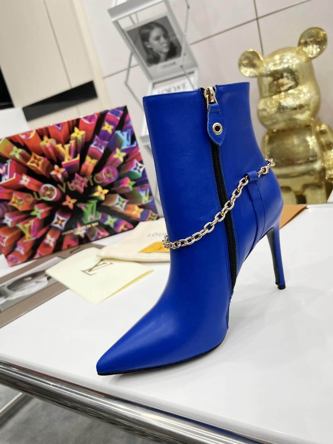 a pair of Louis Vuitton Mansion Chain Ankle Boots In Blue