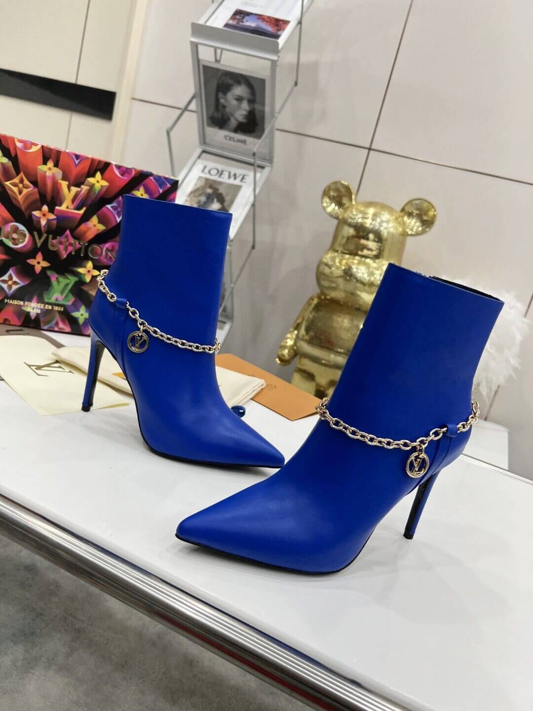a pair of Louis Vuitton Mansion Chain Ankle Boots In Blue