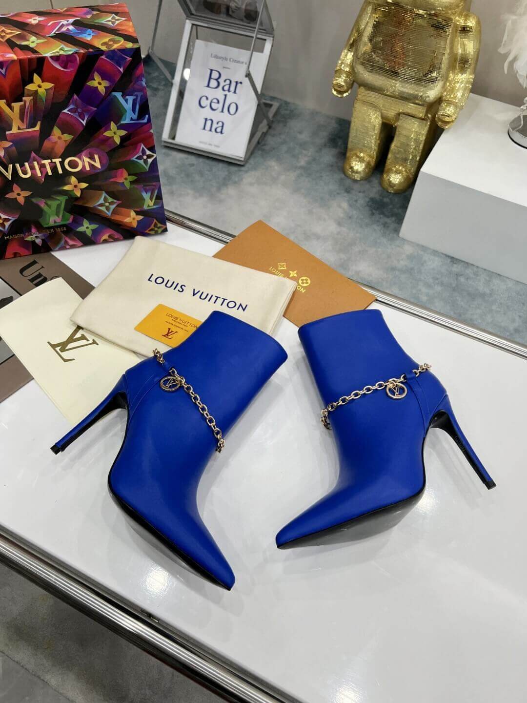 a pair of Louis Vuitton Mansion Chain Ankle Boots In Blue