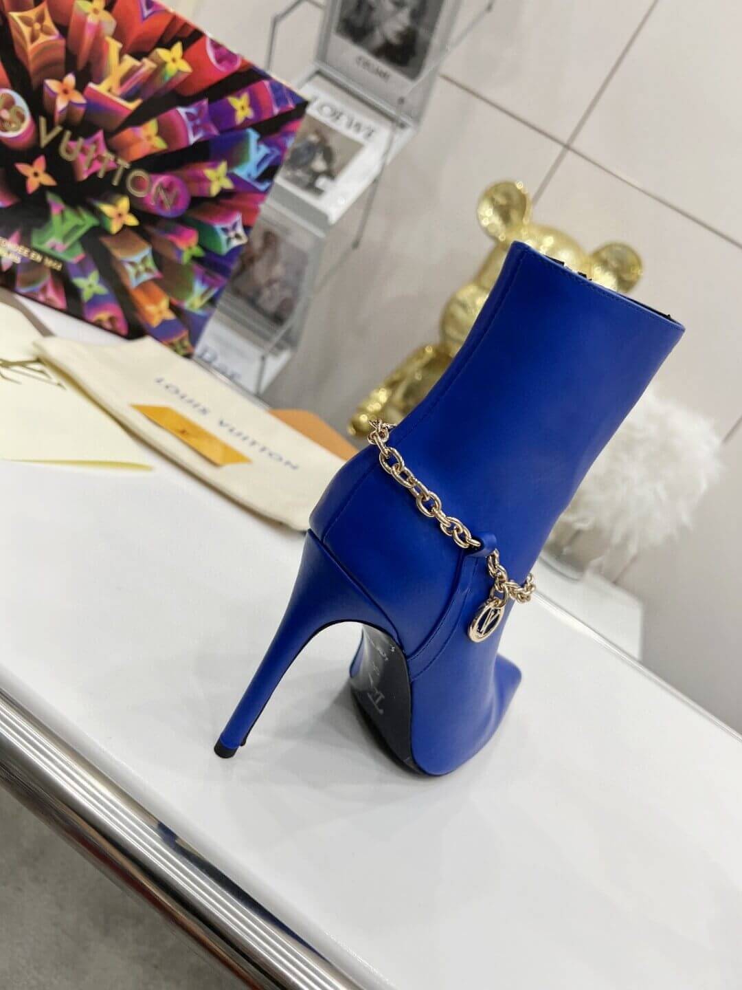 a pair of Louis Vuitton Mansion Chain Ankle Boots In Blue