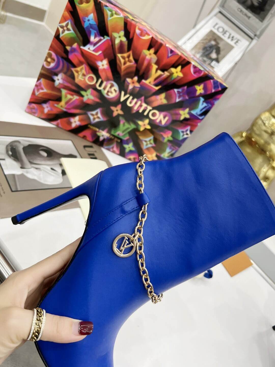a pair of Louis Vuitton Mansion Chain Ankle Boots In Blue