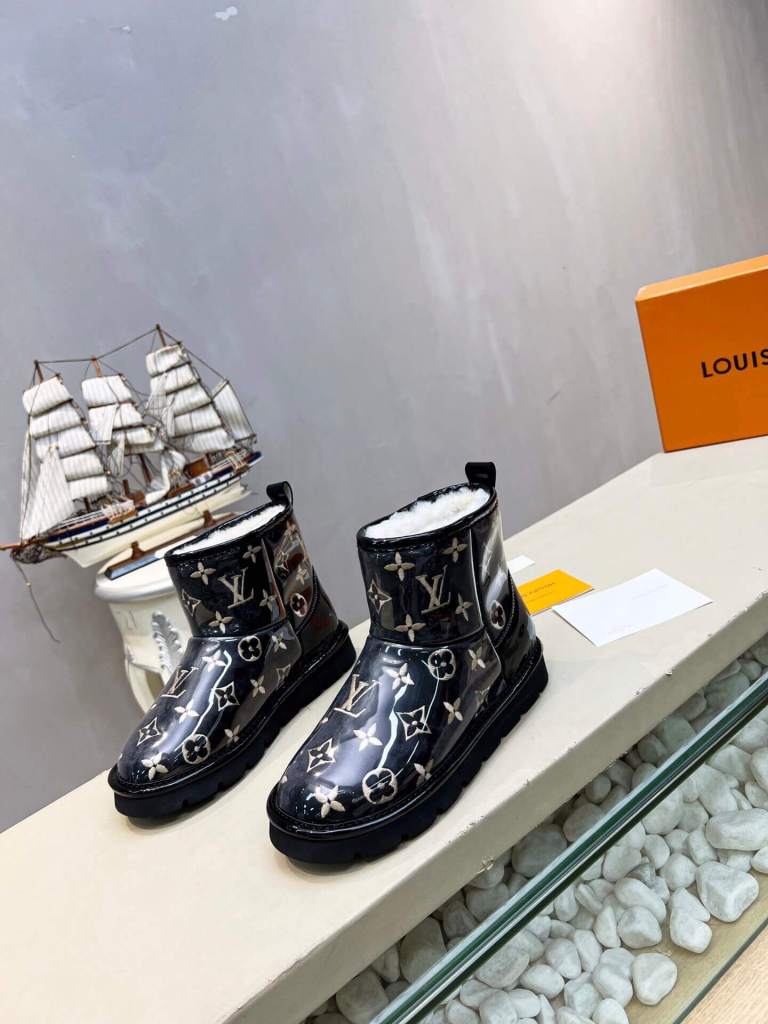 a pair of Louis Vuitton Polar Monogram Shearling Boots Black Patent leather on a shelf