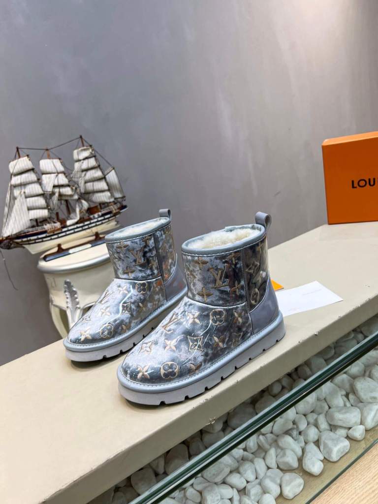 a pair of Louis Vuitton Polar Monogram Shearling Boots In Silver on a shelf