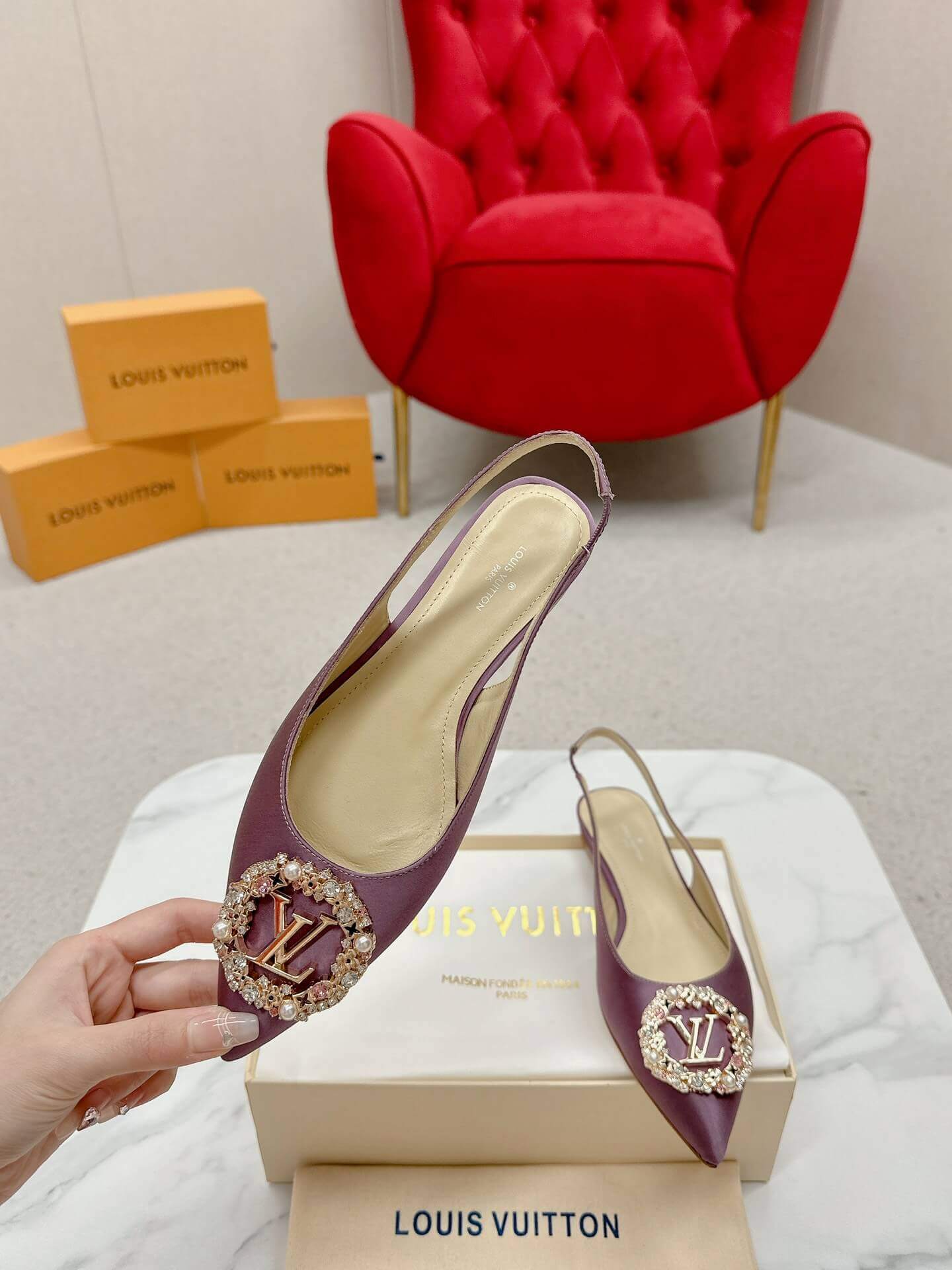 a pair of Louis Vuitton Purple Slingback Flat on a box