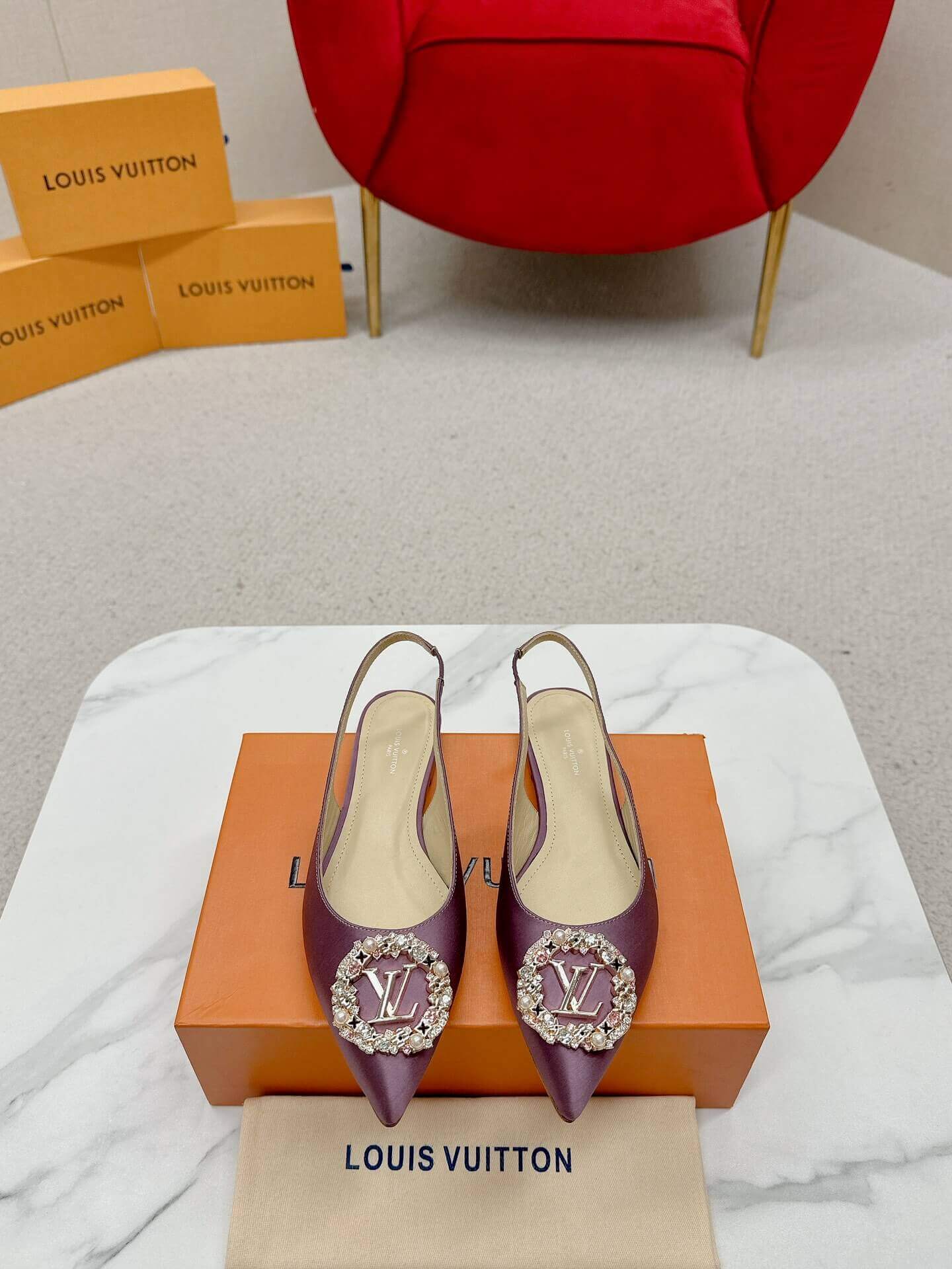a pair of Louis Vuitton Purple Slingback Flat on a box