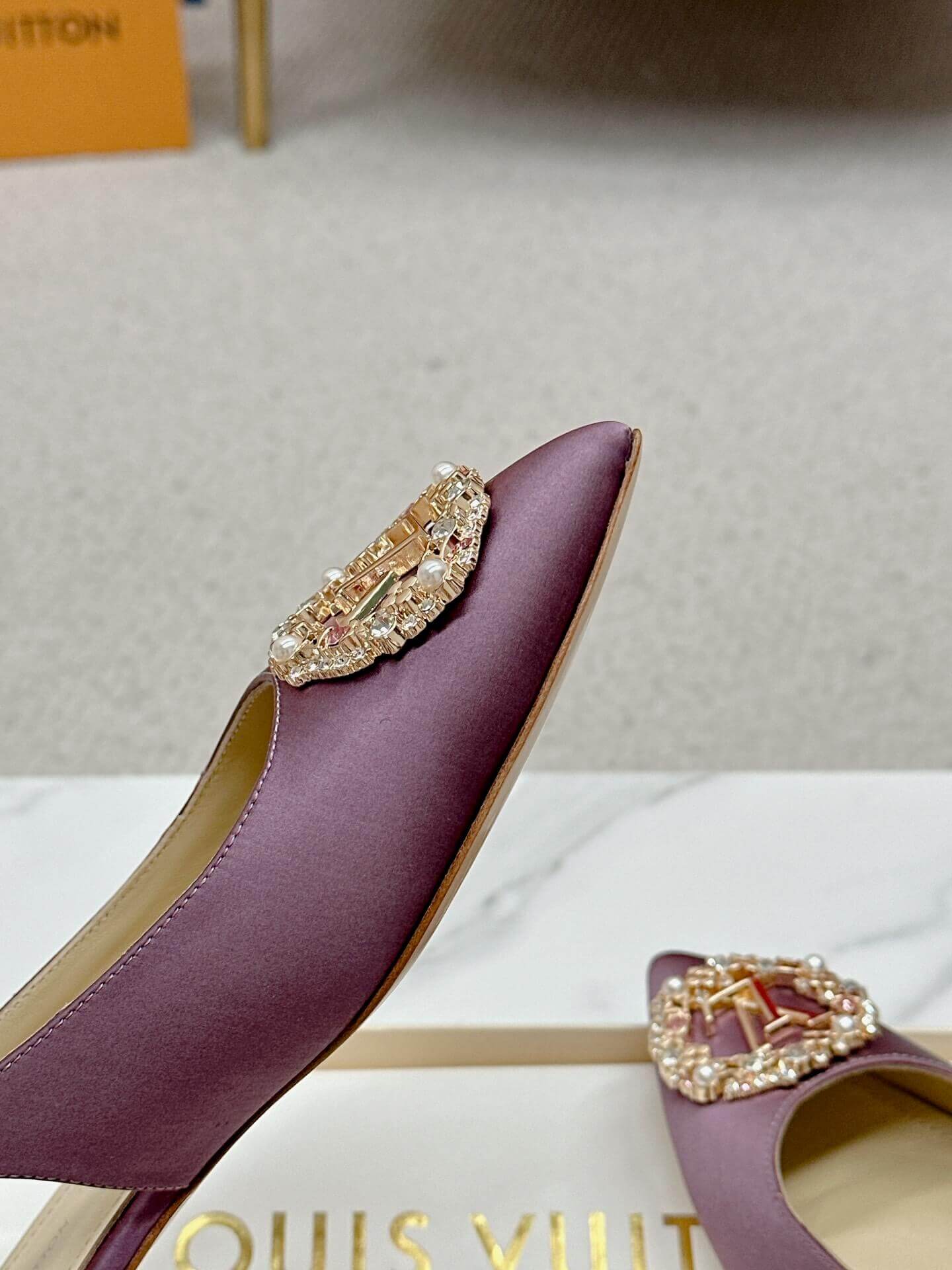 a pair of Louis Vuitton Purple Slingback Flat on a box