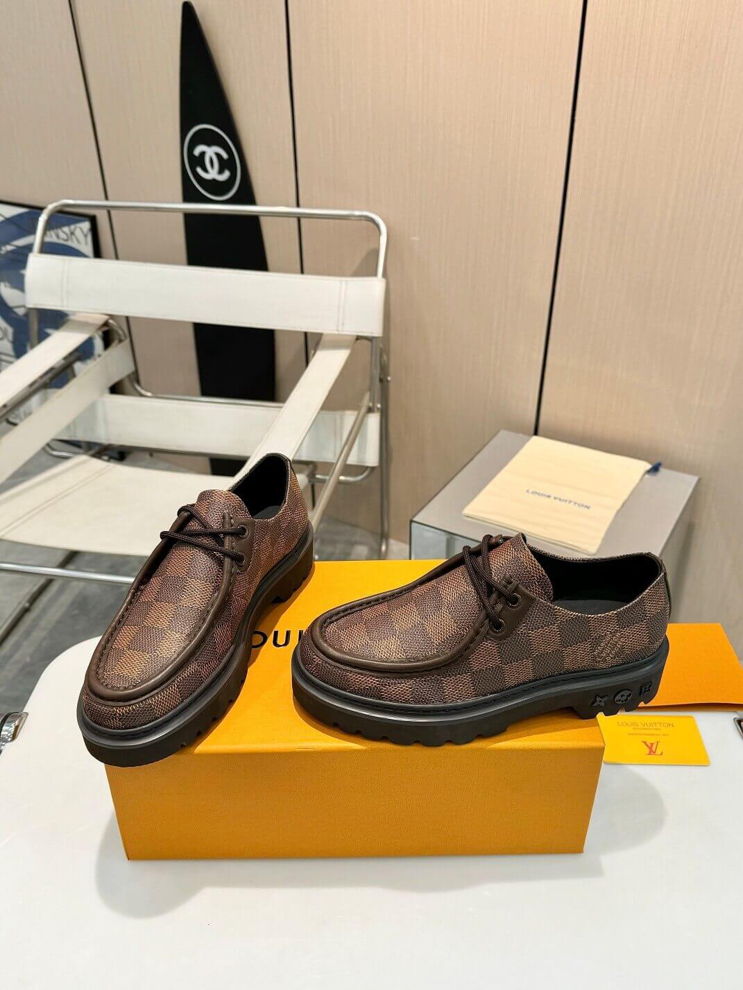 a pair of Louis Vuitton Ranger Derby Ebene Casual Shoes with monogram canvas pattern on a yellow box