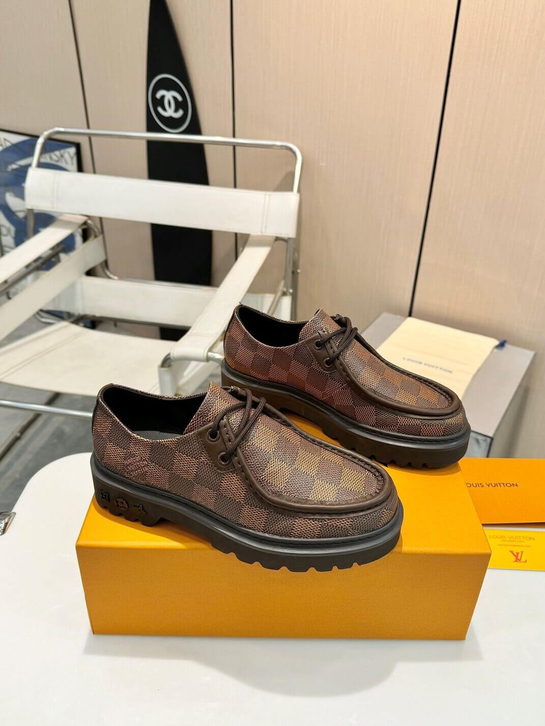a pair of Louis Vuitton Ranger Derby Ebene Casual Shoes with monogram canvas pattern on a yellow box