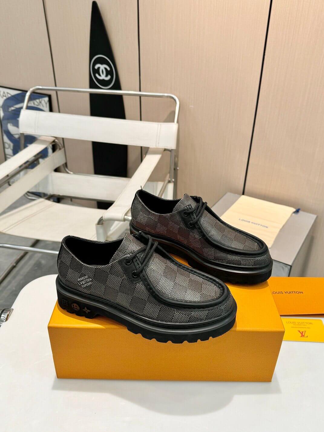a pair of Louis Vuitton Ranger Derby Ebene Casual Shoes with monogram canvas pattern on a yellow box