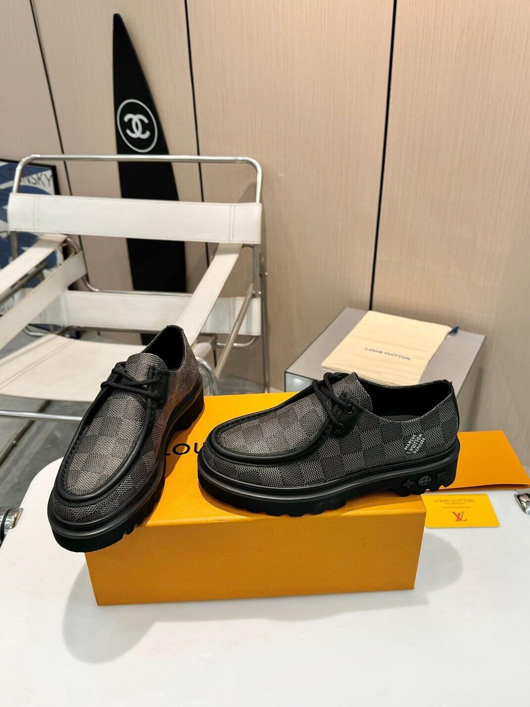 a pair of Louis Vuitton Ranger Derby Ebene Casual Shoes with monogram canvas pattern on a yellow box