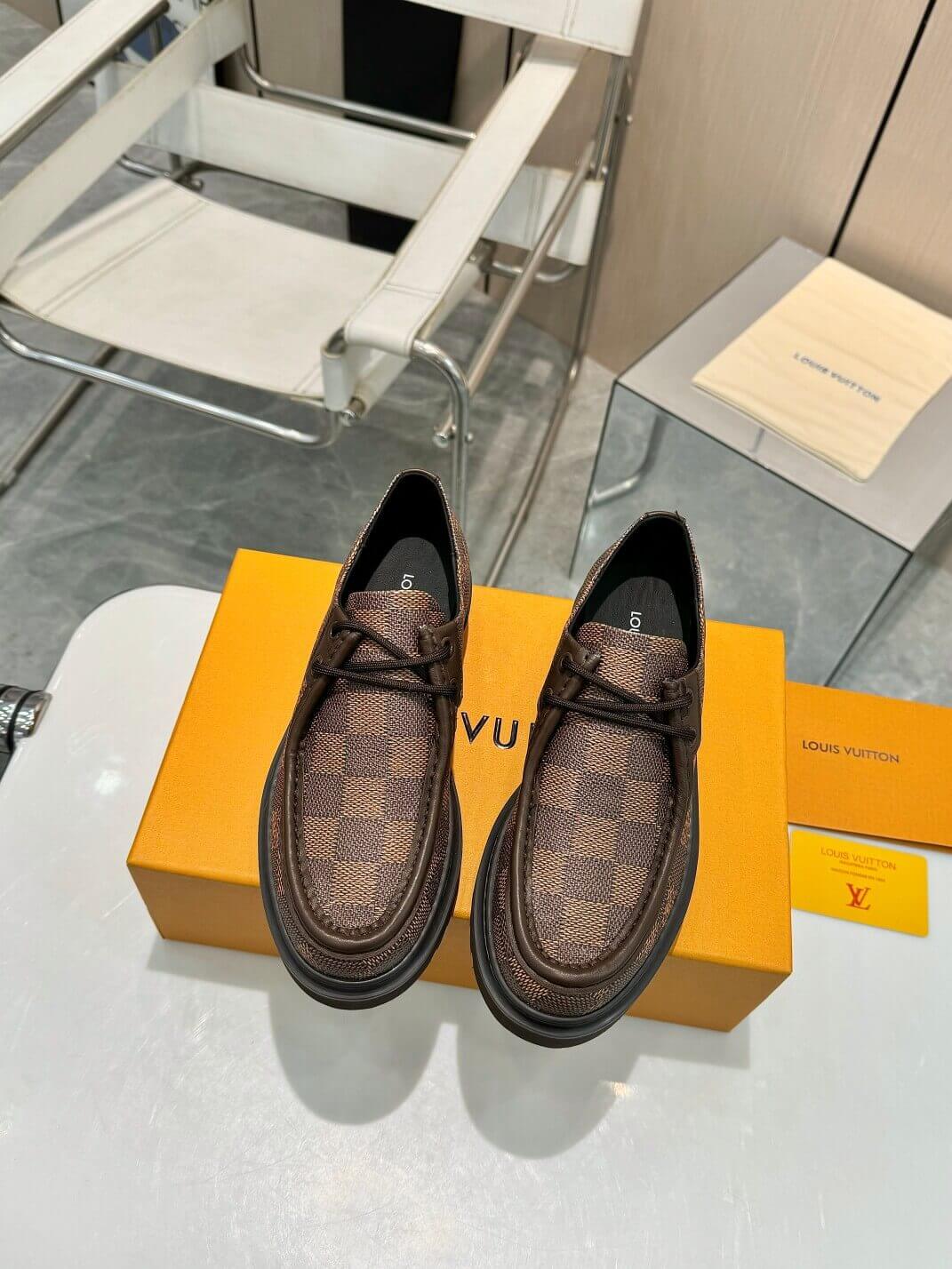 a pair of Louis Vuitton Ranger Derby Ebene Casual Shoes with monogram canvas pattern on a yellow box