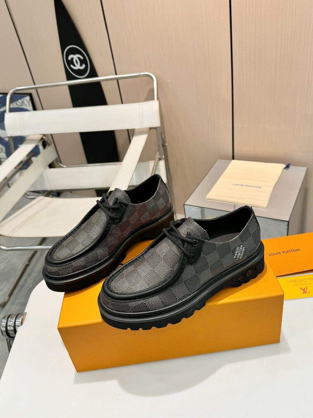 a pair of Louis Vuitton Ranger Derby Ebene Casual Shoes with monogram canvas pattern on a yellow box