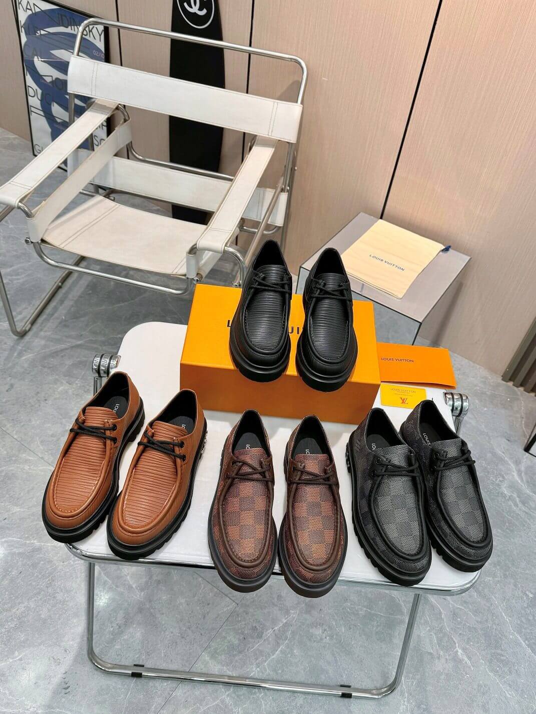 a pair of Louis Vuitton Ranger Derby Ebene Casual Shoes with monogram canvas pattern on a yellow box