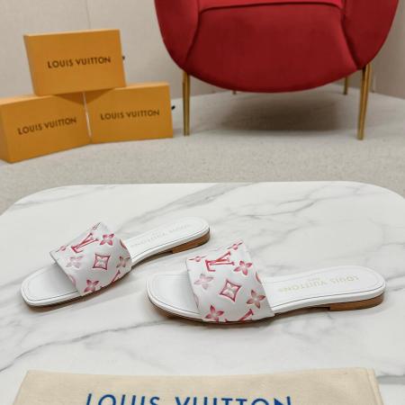 a pair of Louis Vuitton White Monogram Slide Sandals – Pink Edition on a marble surface