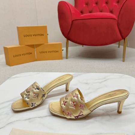 a pair of Louis Vuitton Revival Mule in Gold Monogram-Embossed Lambskin Heel on a marble surface