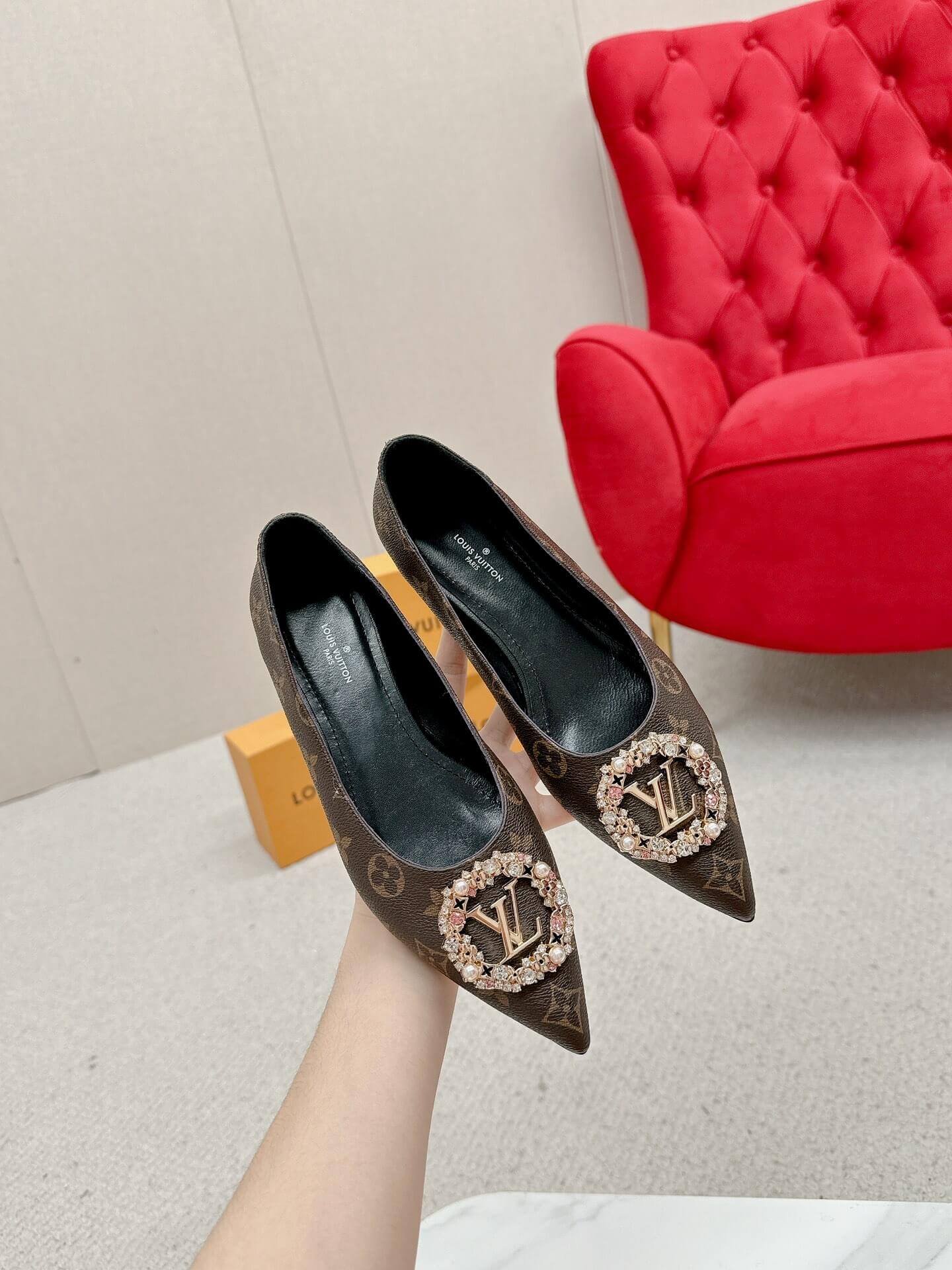 a pair of Louis Vuitton Revival Mule in Monogram Canvas – Crystal‑Embellished Flat Shoe on a box