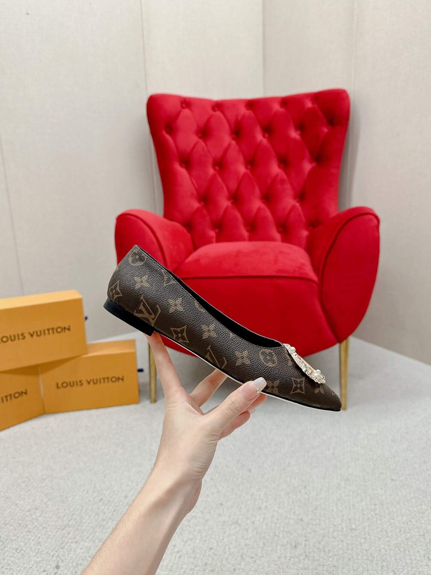 a pair of Louis Vuitton Revival Mule in Monogram Canvas – Crystal‑Embellished Flat Shoe on a box