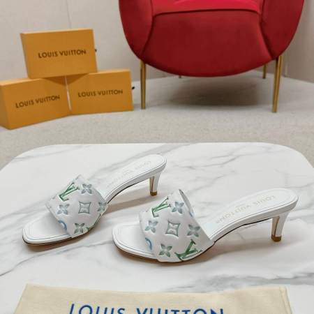 a pair of Louis Vuitton Revival Mule in White and Green Monogram-Embossed Lambskin Heel on a marble surface