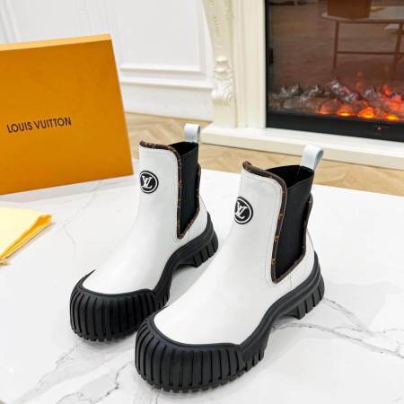 a pair of Louis Vuitton Ruby Flat Ankle Boots (White with Monogram Accents)