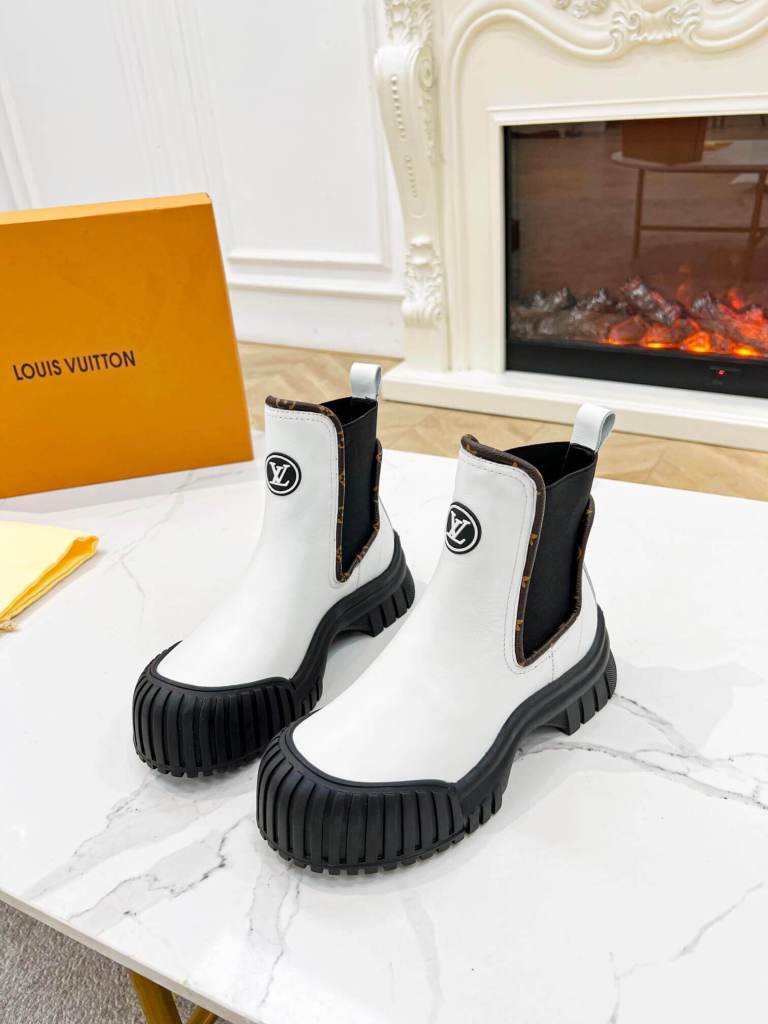 a pair of Louis Vuitton Ruby Flat Ankle Boots (White with Monogram Accents)