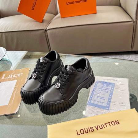 a pair of Louis Vuitton Ruby Flat Derby Shoe in black on a glass table