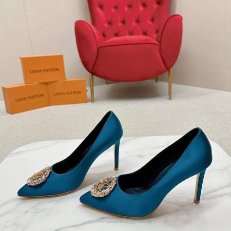 a pair of Louis Vuitton Satin Elegance Pointed Toe Heels – Blue Jewel Edition on a marble surface
