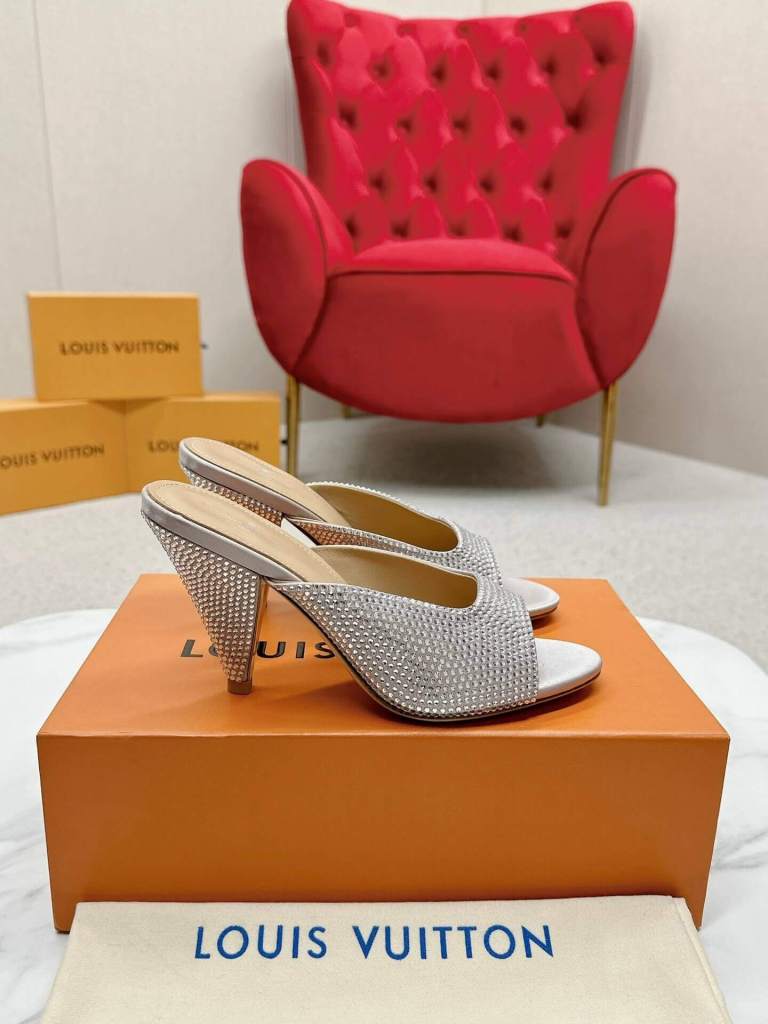 a pair of Louis Vuitton Super Mule – Silver Crystal Elegance on a box