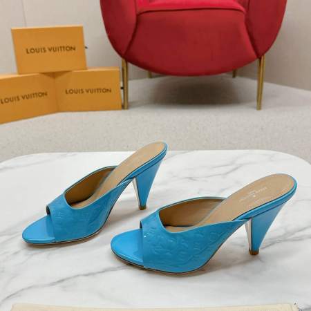 a pair of Louis Vuitton Super Mule in Sky‑Blue Patent on a marble surface