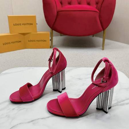 a pair of Louis Vuitton Velvet Crystal Silhouette Sandals with Crystal‑Fringe Block Heels in Hot Pink on a marble table