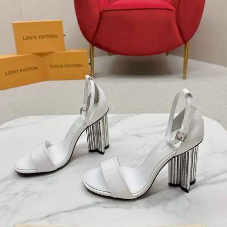a pair of Louis Vuitton White Patent Leather Silhouette Sandals with Monogram Heel on a box